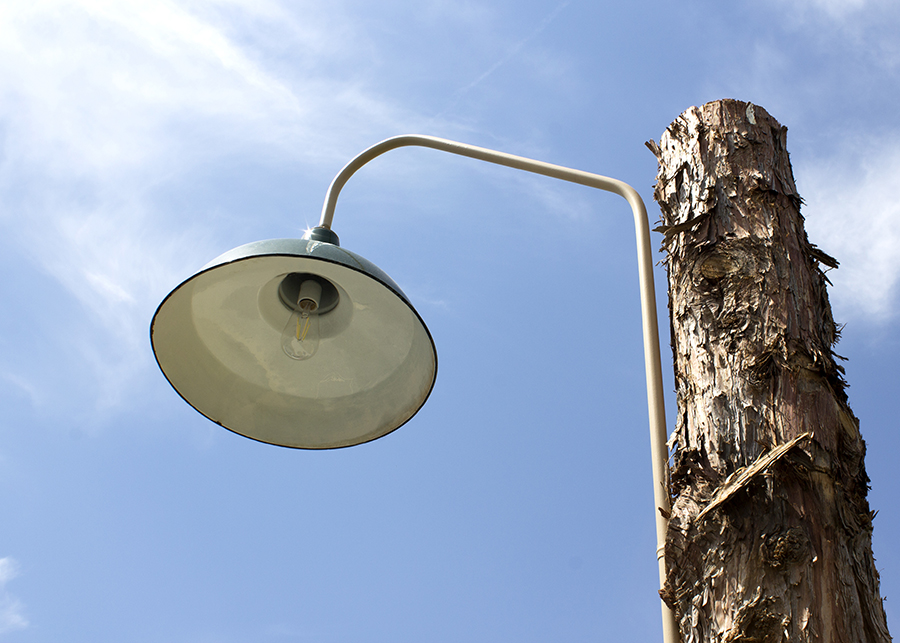 A close up of the pavilions light poles made from untreated pine logs